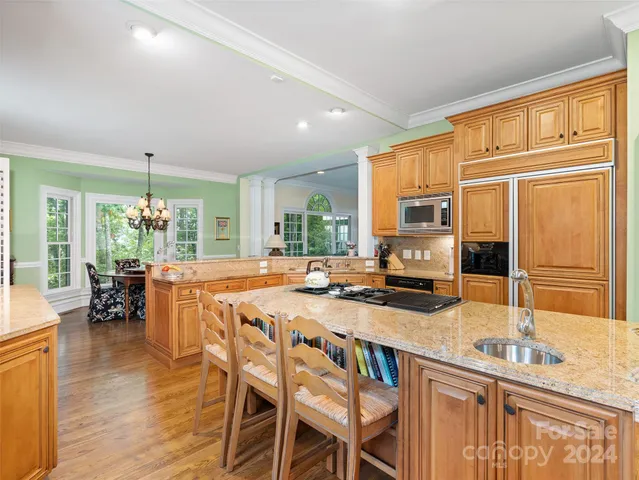 a large kitchen with a table and chairs