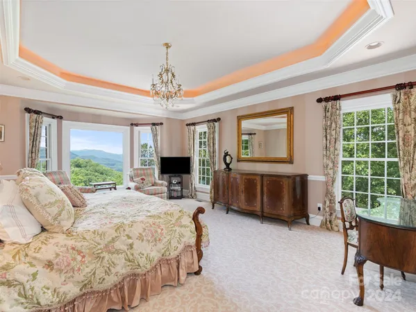 a bedroom with a bed and a chandelier