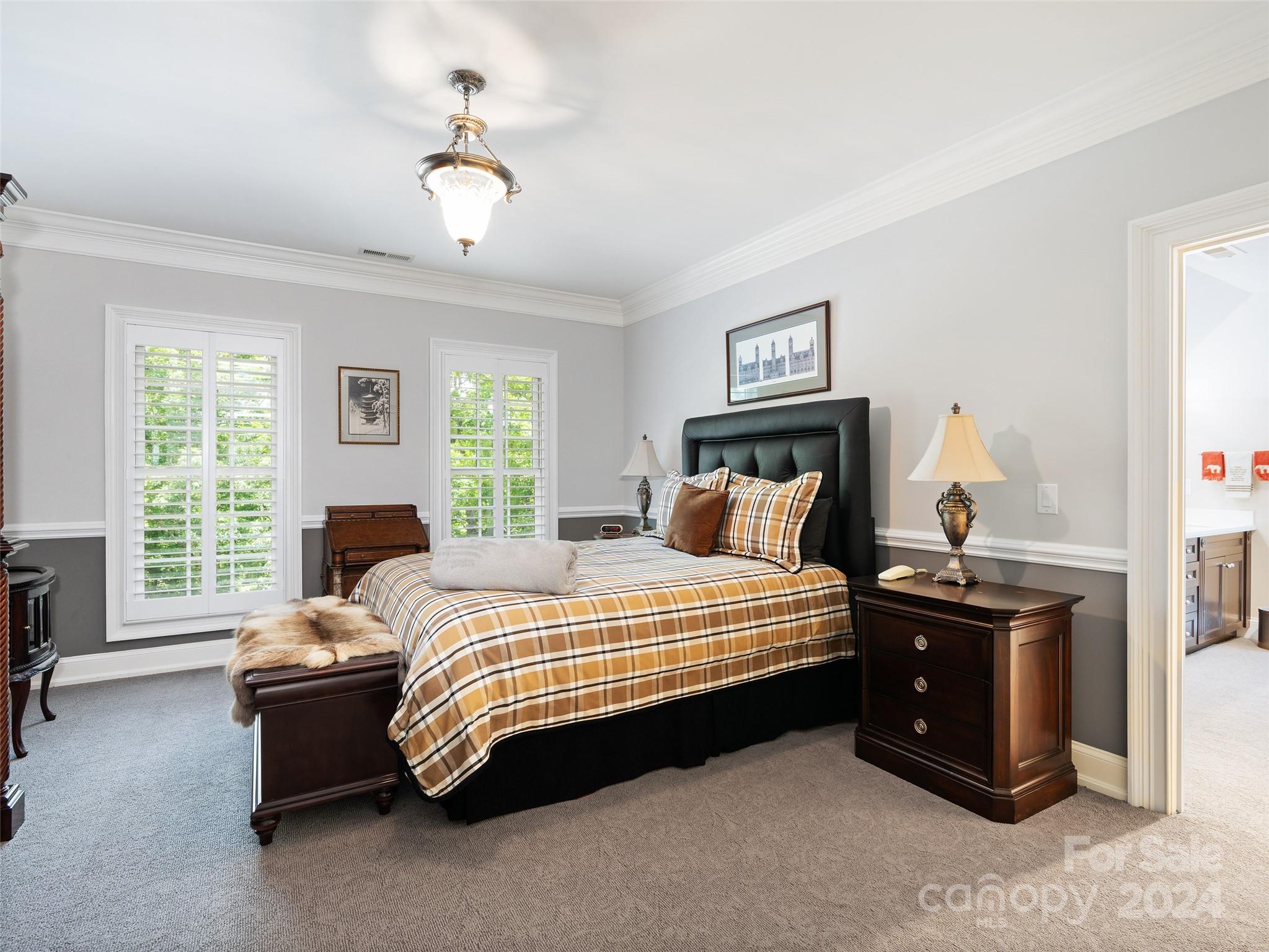1767 Ridgeway Street Sylva, NC 28779 - Photo 21 of 46 a bedroom with a bed and a chandelier