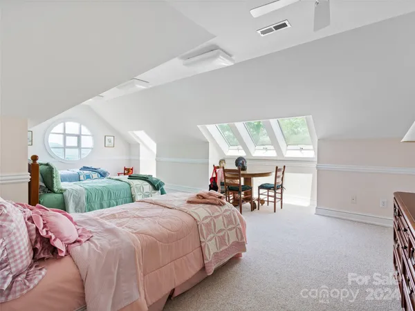 a balcony with wooden floor and trees in the background