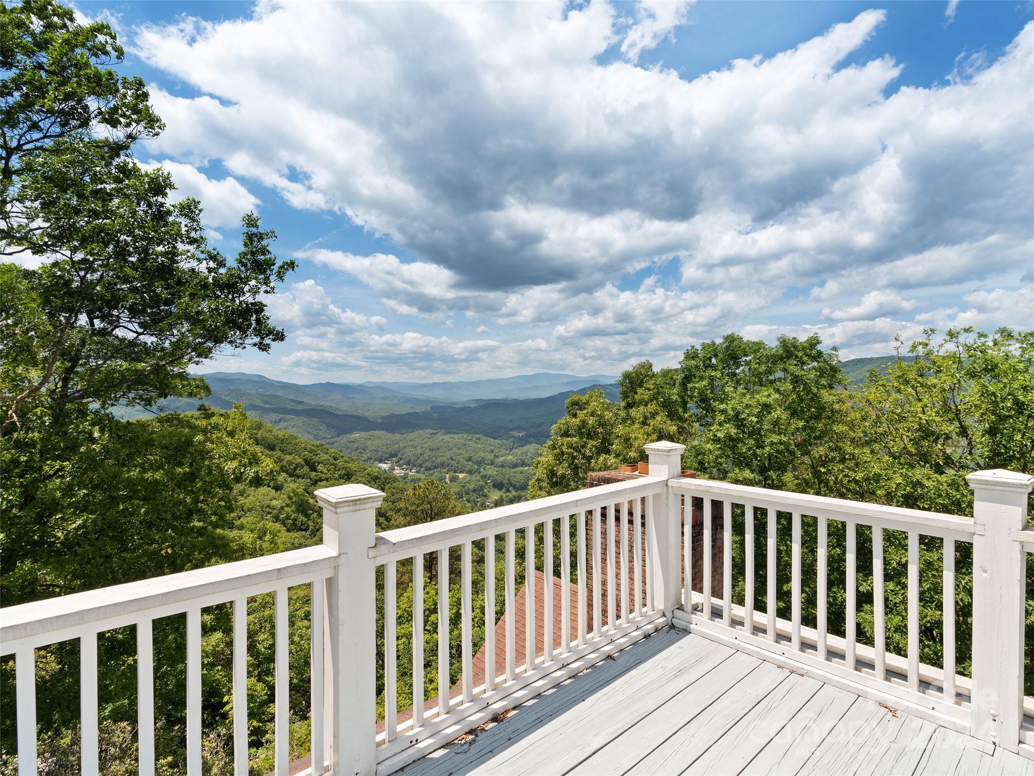 1767 Ridgeway Street Sylva, NC 28779 - Photo 26 of 46 a balcony with wooden floor and trees in the background