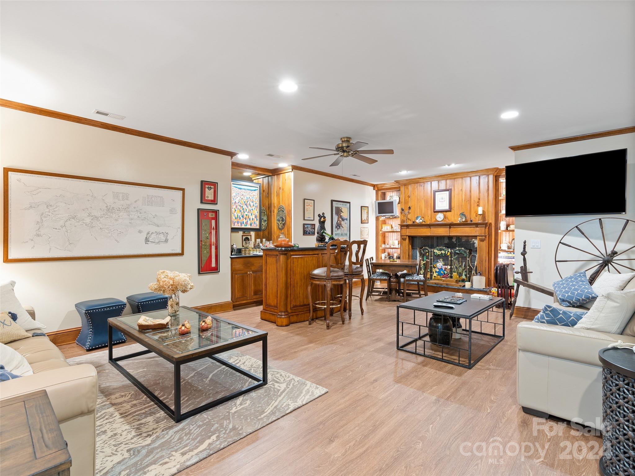 1767 Ridgeway Street Sylva, NC 28779 - Photo 28 of 46 a living room with furniture a fireplace and a flat screen tv