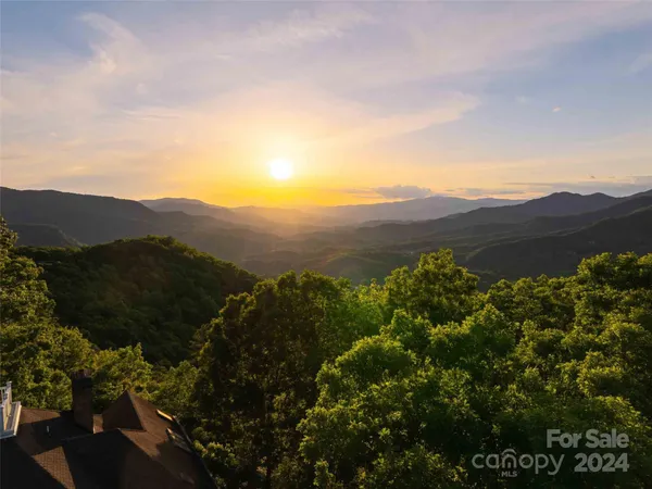 an aerial view of a house with a street