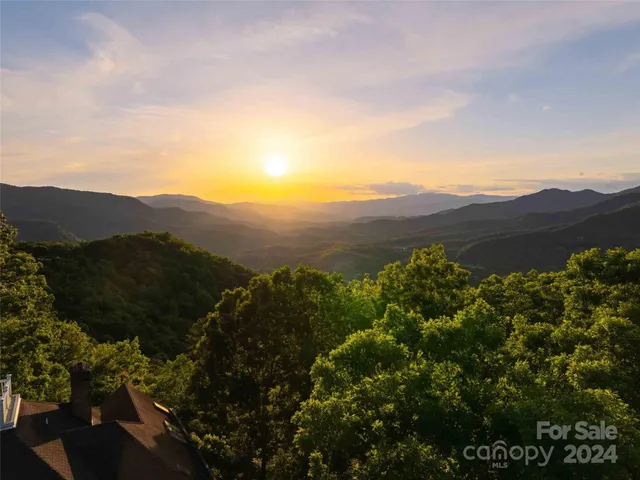 an aerial view of a house with a street