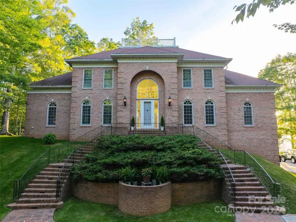 a view of a lush green field with lots of bushes