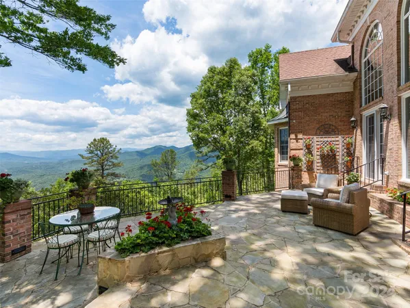 a view of a patio with couches table and chairs and potted plants