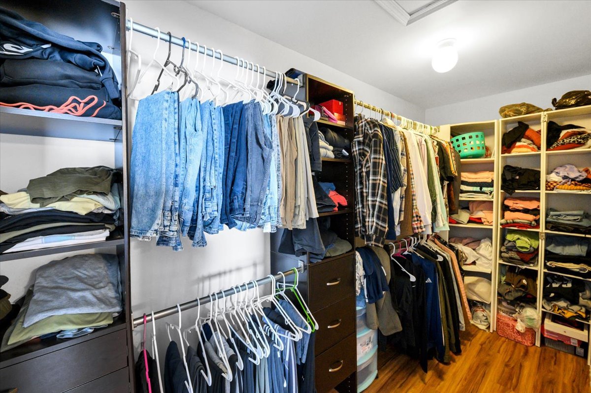 322 Zinnia Drive Romeoville, IL 60446 - Photo 19 of 42 a view of walk in closet with clothes and shoes