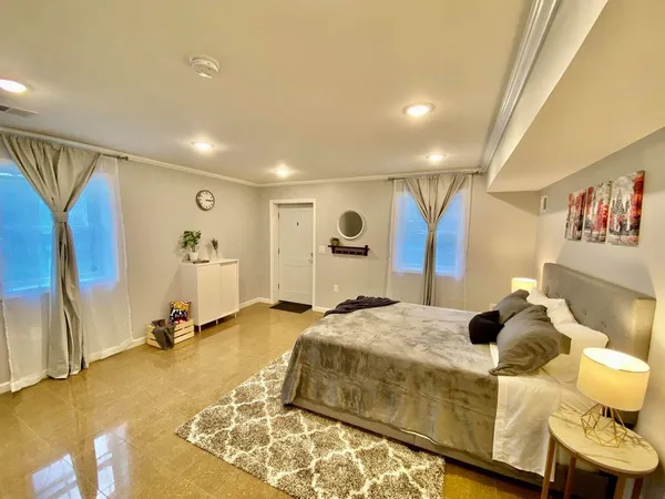 a view of a kitchen with kitchen island stainless steel appliances a stove a sink and a refrigerator