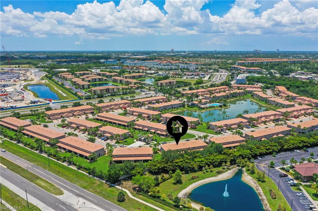 3916 Cherrybrook Loop Fort Myers, FL 33966 - Photo 25 of 31 Aerial perspective showcasing a residential community with multiple multi-story buildings featuring terracotta-style roofs