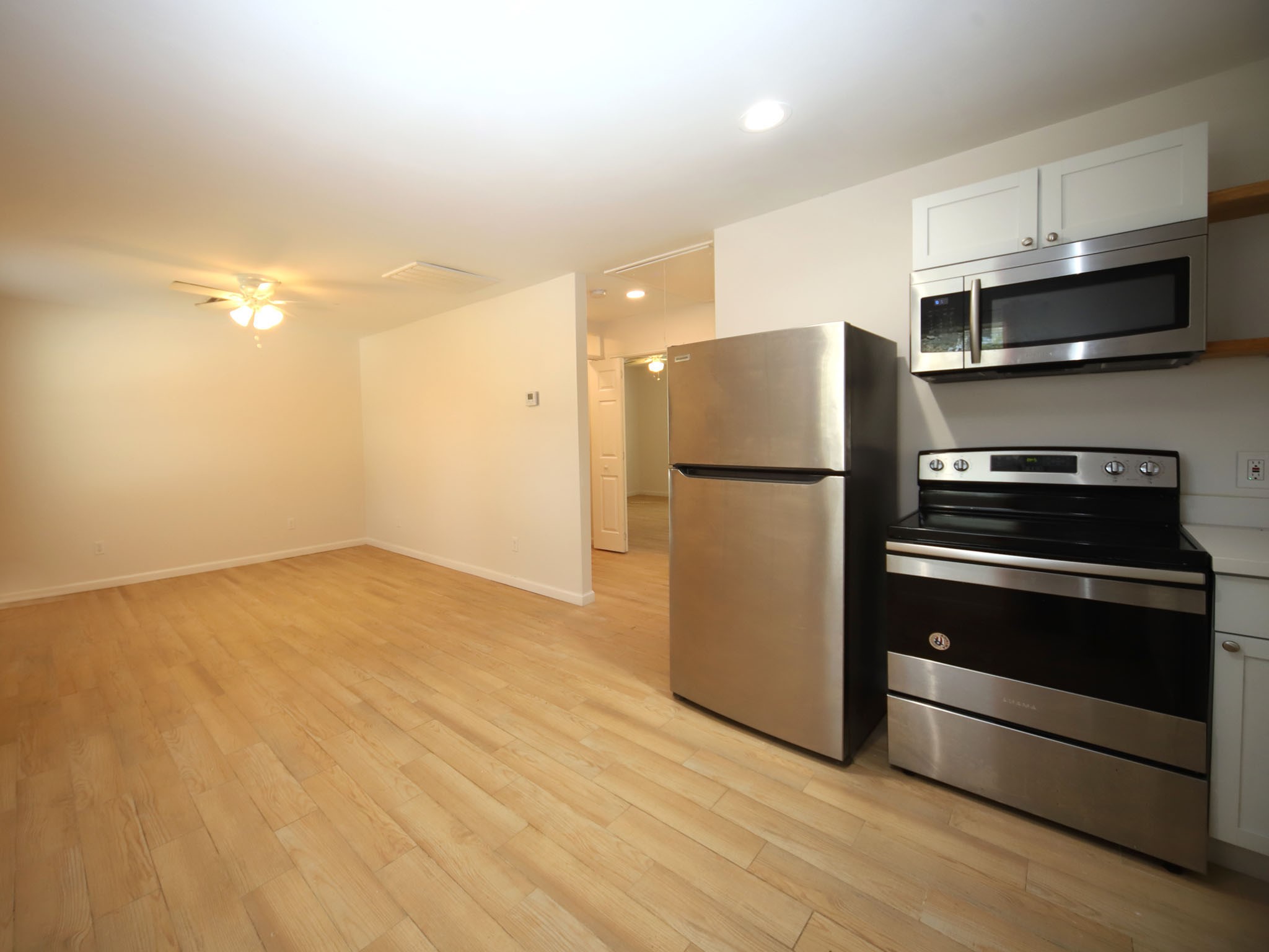 6709 Greenhurst Street, Unit A Houston, TX 77091 - Photo 2 of 8 a kitchen with stainless steel appliances a refrigerator and a stove top oven