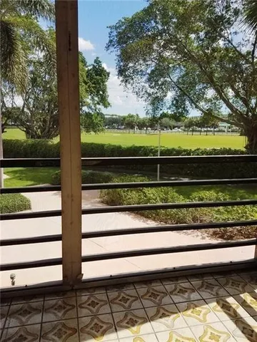 a view of a yard with wooden fence