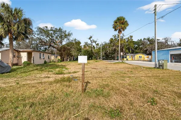 a swimming pool with yard in front of it