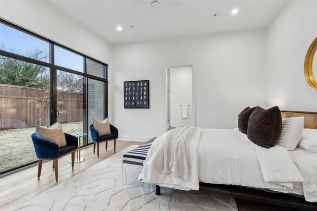 a bedroom with a bed and a large window