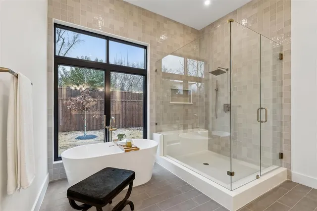 a bathroom with a tub shower and sink