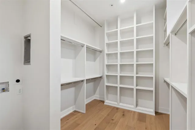 a view of walk in closet with empty racks