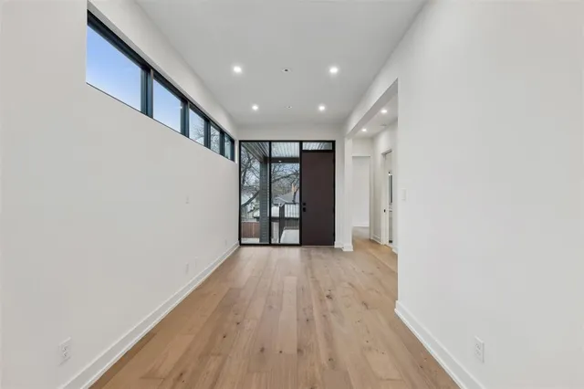 a view of hallway with wooden floor