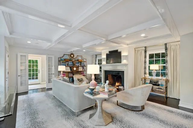 a view of living room filled with furniture and floor to ceiling windows