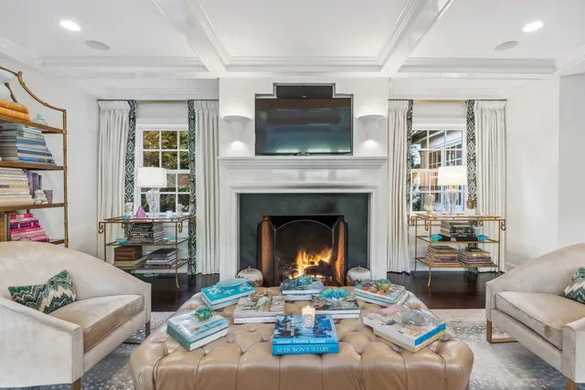 a view of a hallway with wooden floor and windows