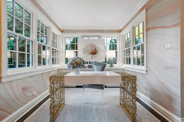 a bedroom with a bed a table and chair