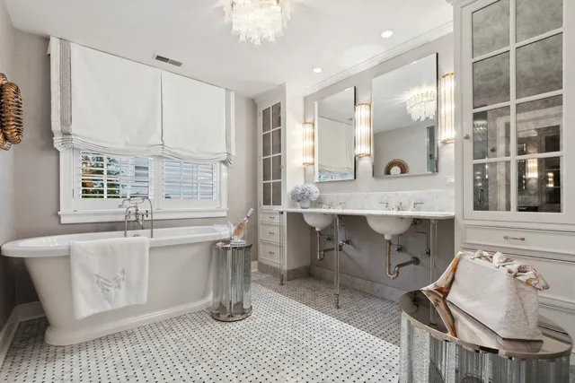 a bathroom with a granite countertop sink a mirror and shower