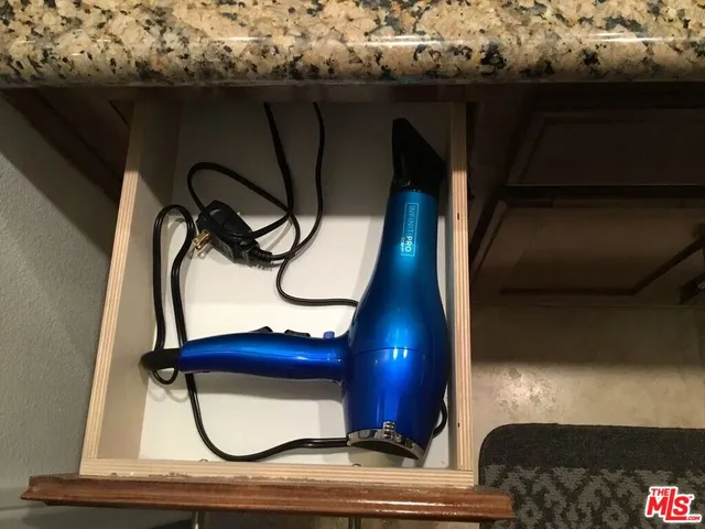 a bathroom with a granite countertop shower and a sink