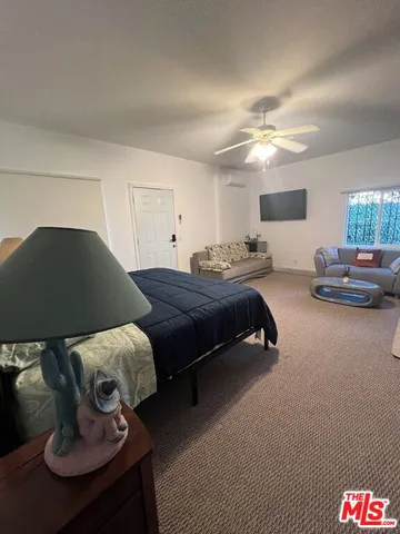 a bedroom with a bed and dresser