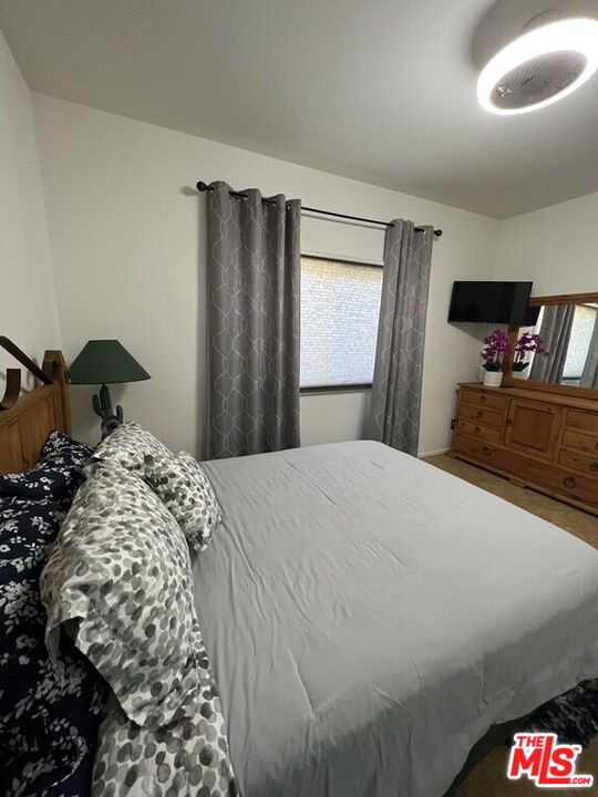 Undisclosed Address Desert Hot Springs, CA 92240 - Photo 15 of 44 a bedroom with a bed and dresser