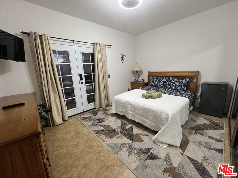 Undisclosed Address Desert Hot Springs, CA 92240 - Photo 19 of 44 a bedroom with a bed and a walk in closet