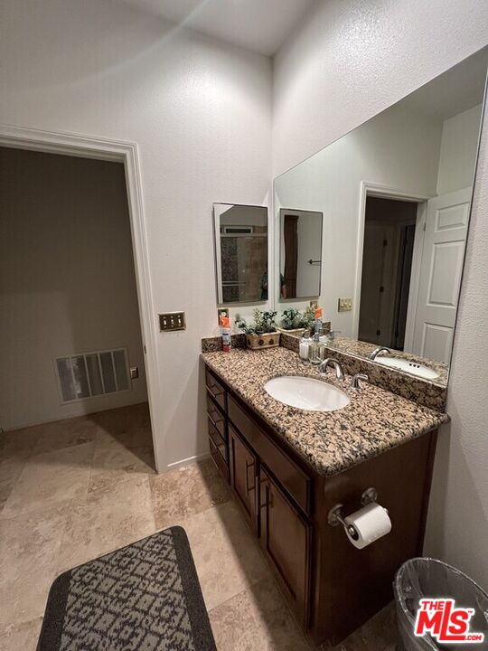 Undisclosed Address Desert Hot Springs, CA 92240 - Photo 21 of 44 a bathroom with a granite countertop sink and a mirror