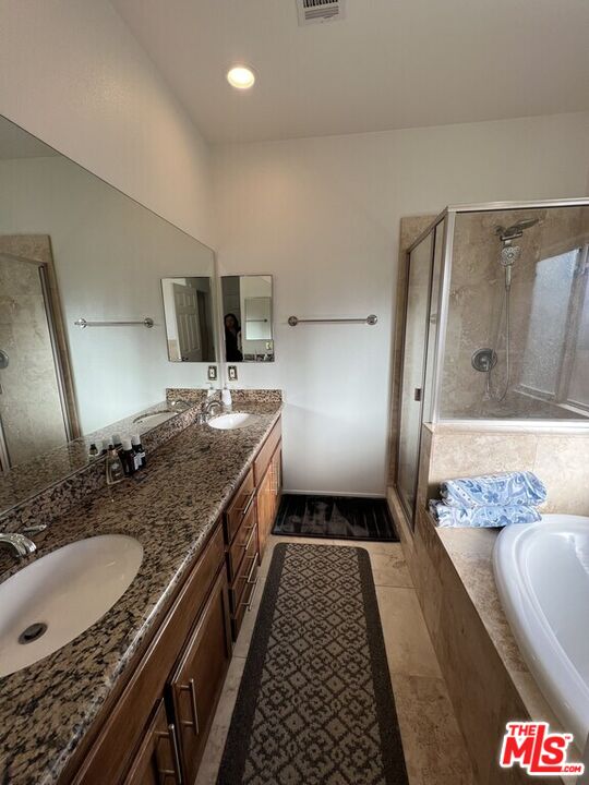 Undisclosed Address Desert Hot Springs, CA 92240 - Photo 32 of 44 a spacious bathroom with a granite countertop sink a toilet a mirror and shower