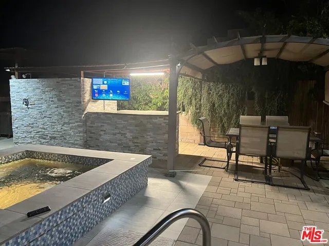 a bathroom with a sink mirror and a bathtub