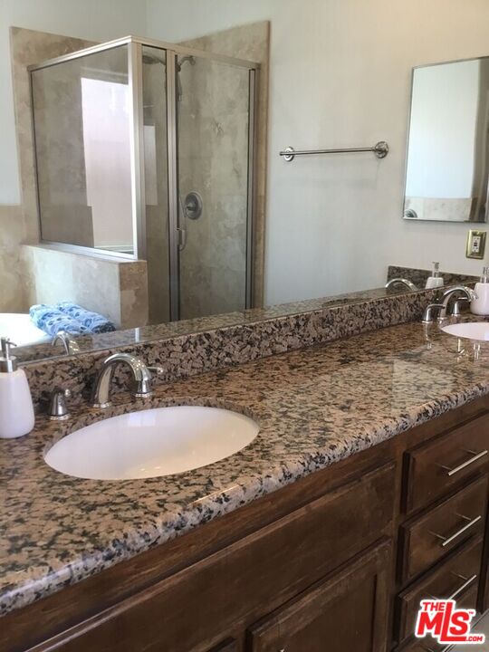 Undisclosed Address Desert Hot Springs, CA 92240 - Photo 9 of 44 a bathroom with a sink and a mirror