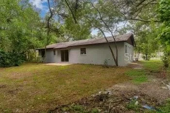 a house with trees in the background