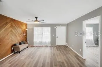 wooden floor in an empty room with a window