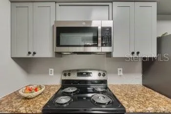 a kitchen with a stove and a microwave