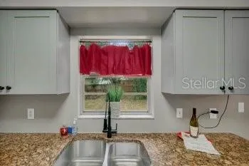 a room with a window and a rug