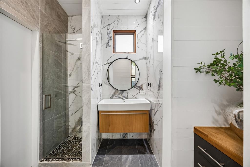 4323 Middleton Road Dallas, TX 75229 - Photo 37 of 40 Full bath in the cabana featuring a walk in shower and modern finishes, offering a comfortable and convenient space for guests or poolside use.