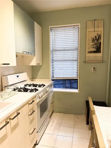 a kitchen with a refrigerator and a sink