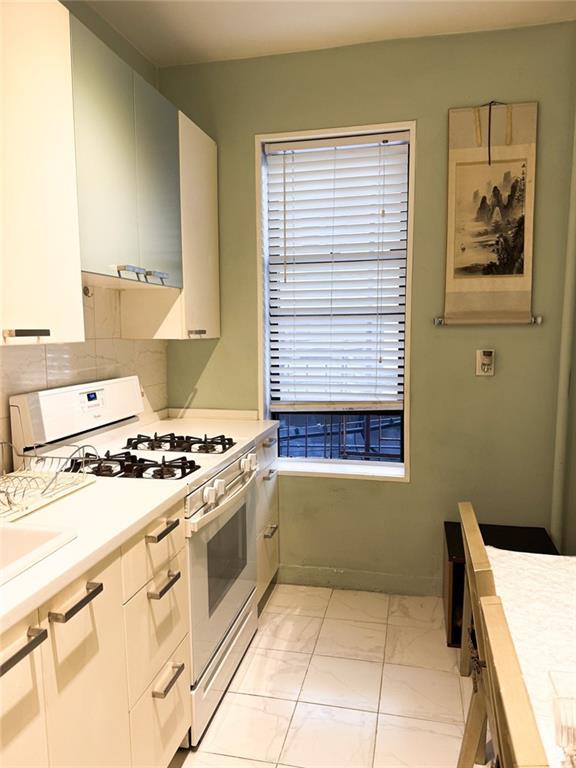 3039 Ocean Parkway, Unit B6 Brooklyn, NY 11235 - Photo 3 of 12 a kitchen with a stove a sink and a window