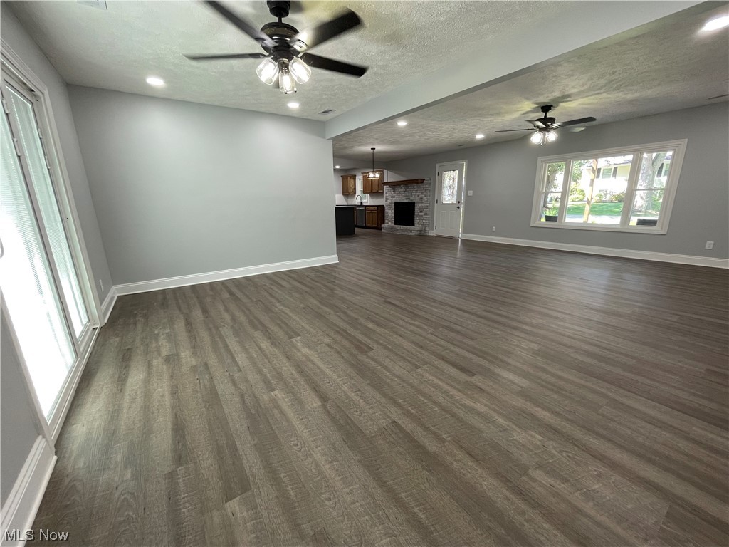 1857 Sterling Road Madison, OH 44057 - Photo 9 of 33 Hardwood floored living room featuring a textured ceiling and ceiling fan