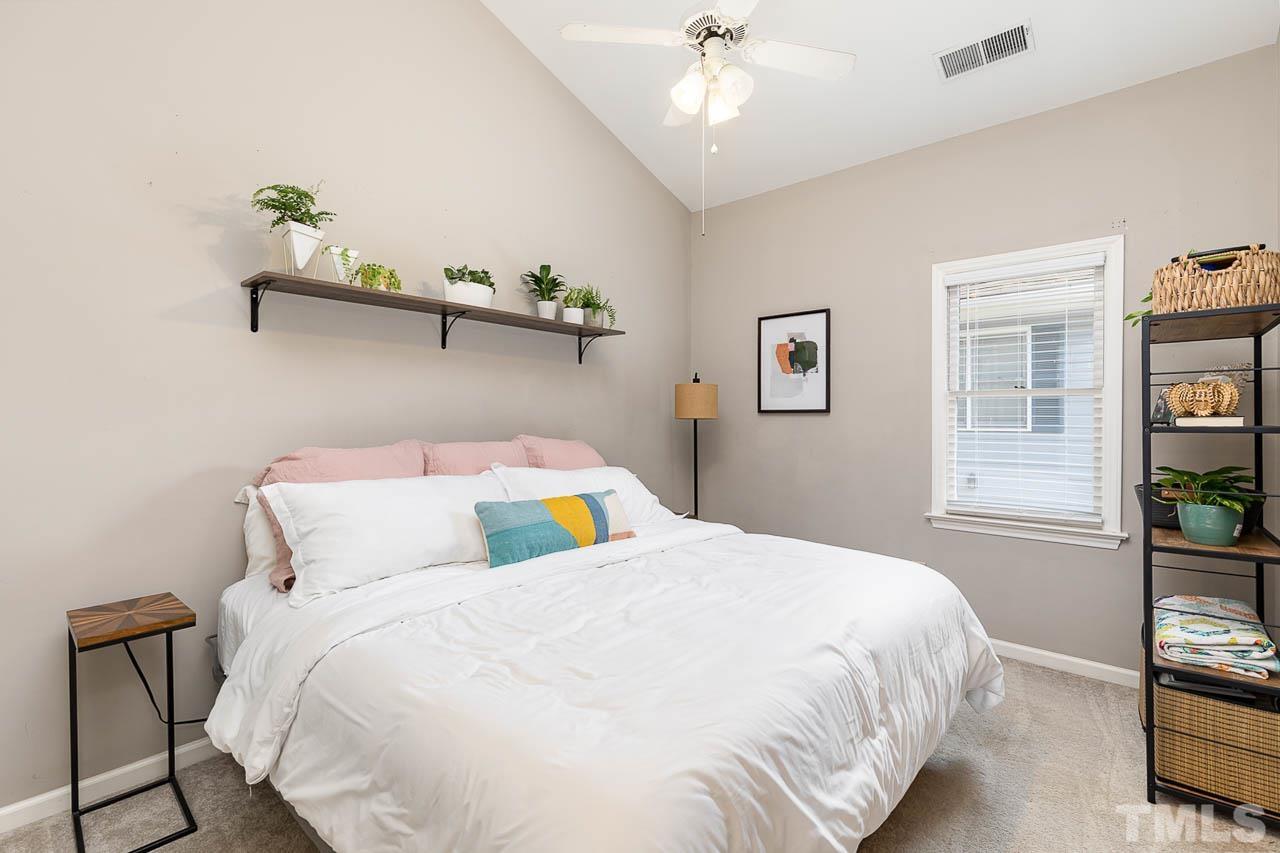 1400 Barton Pl Drive Raleigh, NC 27608 - Photo 17 of 25 a bedroom with a bed and a chandelier