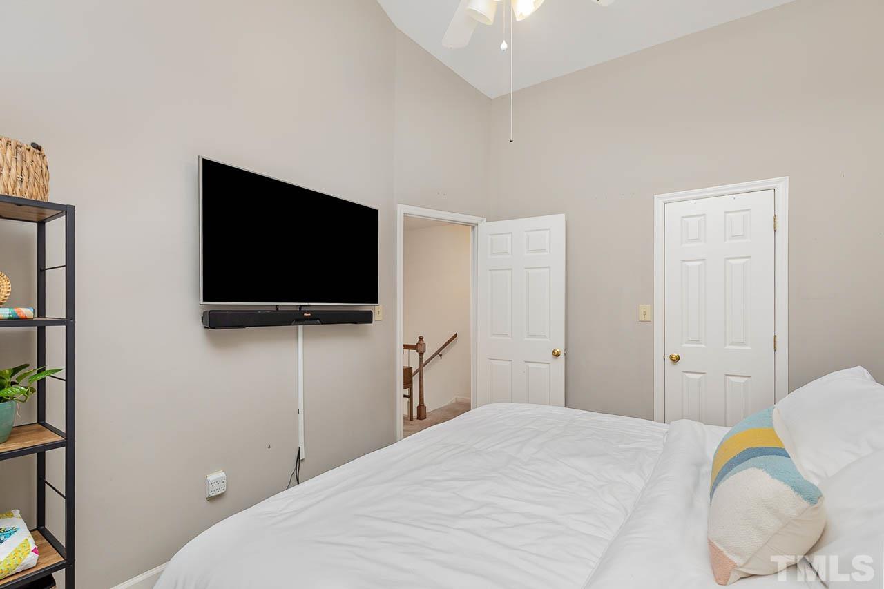 1400 Barton Pl Drive Raleigh, NC 27608 - Photo 18 of 25 a bedroom with a bed and a flat screen tv