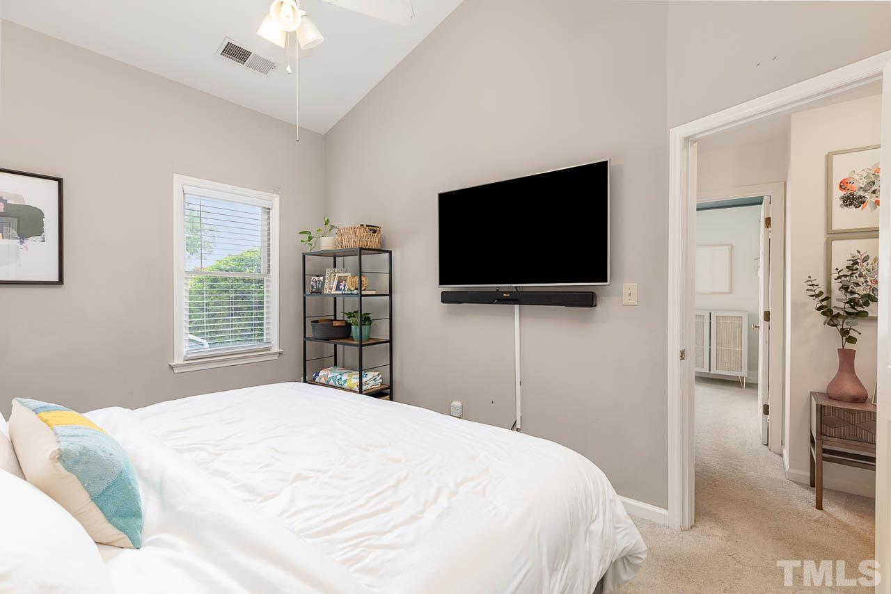 1400 Barton Pl Drive Raleigh, NC 27608 - Photo 19 of 25 a bedroom with a bed and a flat screen tv