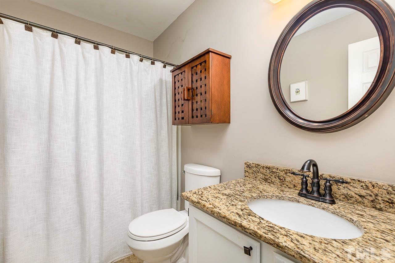 1400 Barton Pl Drive Raleigh, NC 27608 - Photo 20 of 25 a bathroom with a granite countertop sink and a mirror