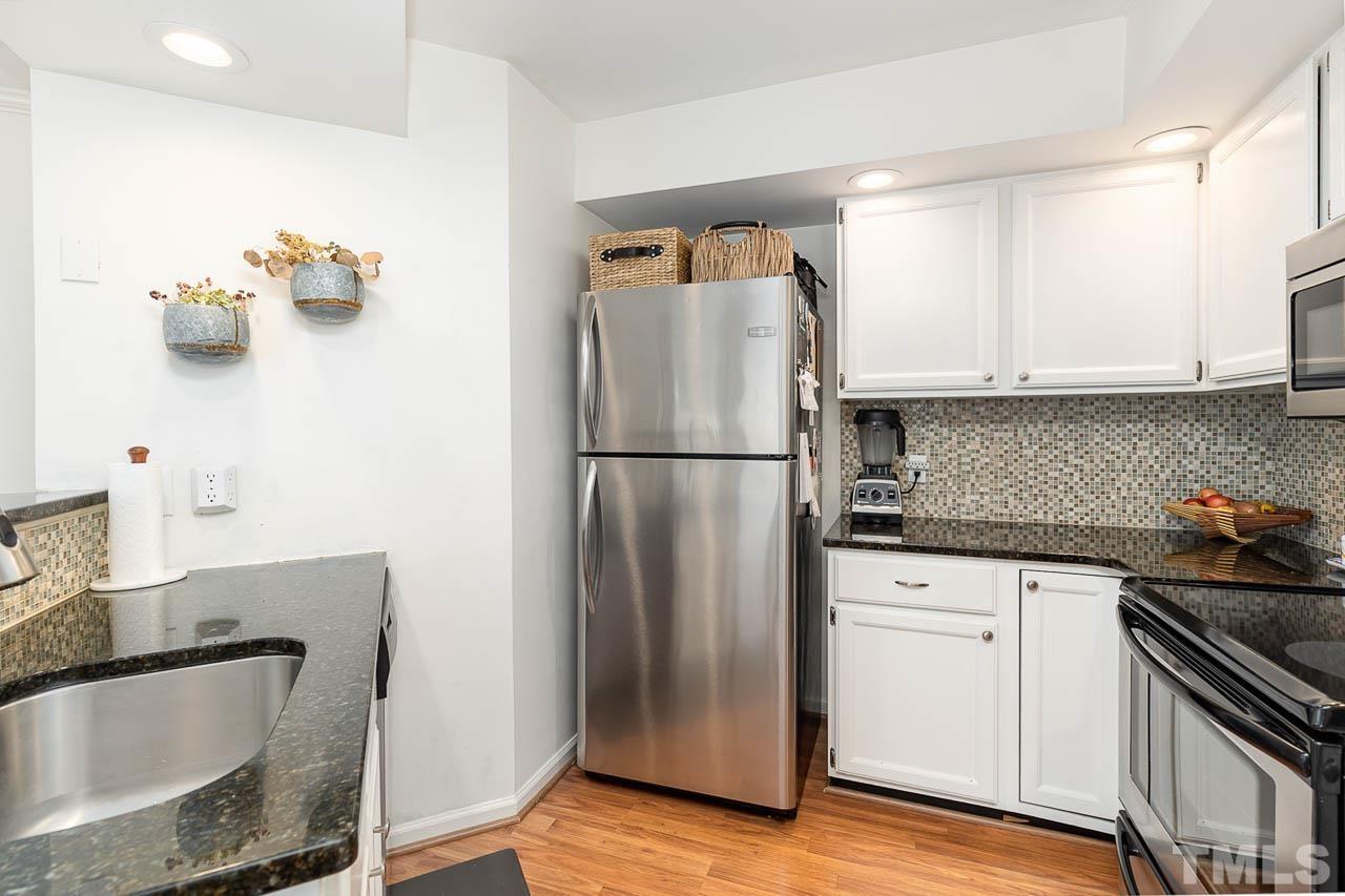 1400 Barton Pl Drive Raleigh, NC 27608 - Photo 8 of 25 a kitchen with stainless steel appliances granite countertop a refrigerator sink and stove