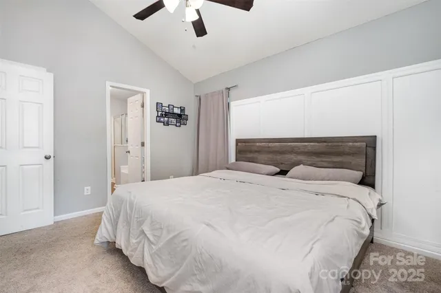 a bedroom with a bed and a ceiling fan