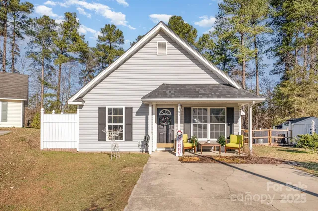 a view of a house with backyard porch and sitting area