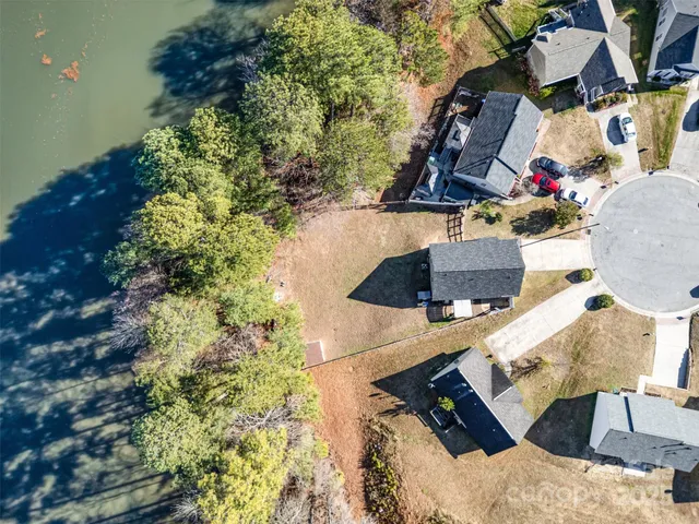 an aerial view of a house with a lake view