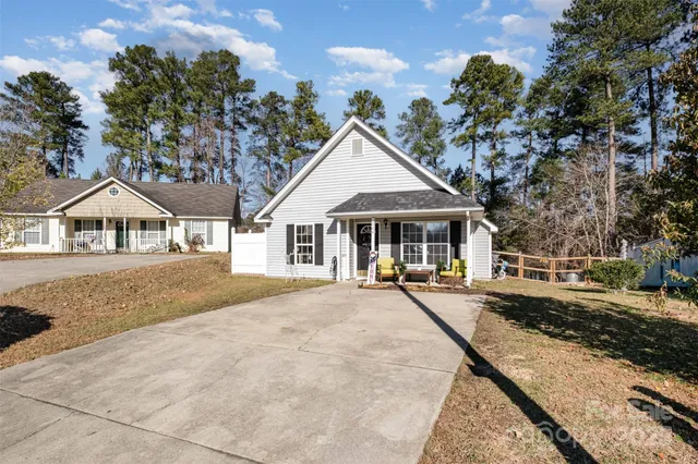 a front view of a house with yard and green space