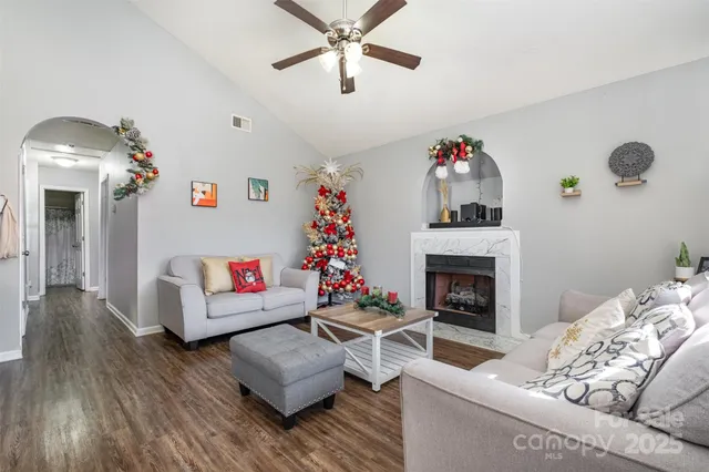 a living room with furniture and a fireplace